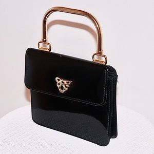 Little black hand held accessory purse
